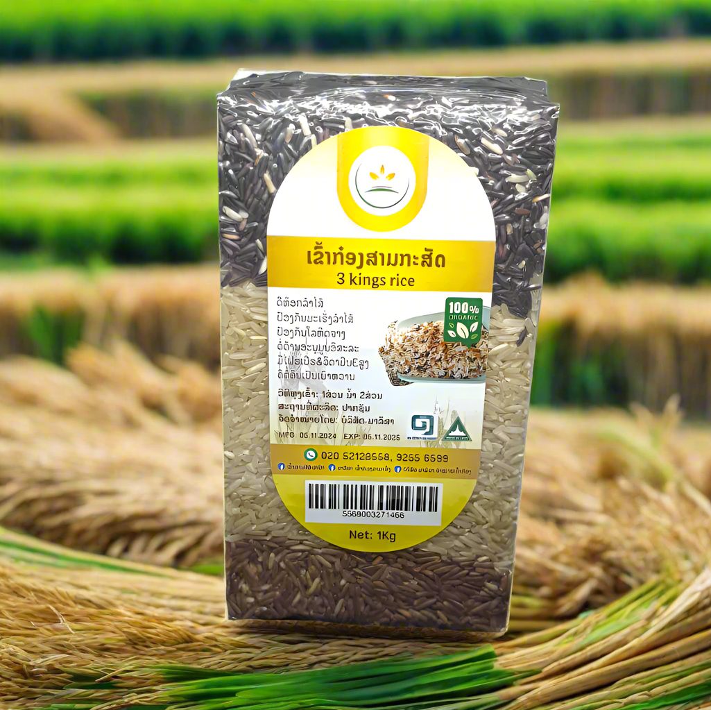 A package of 3 Kings Rice featuring a combination of Rice Berry, Brown Rice, and Khao Man Pou, displayed against a natural background with rice plants in the foreground.