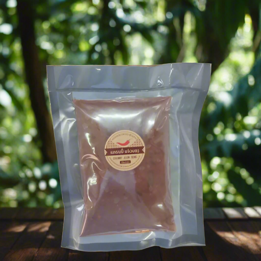 A 500g vacuum-sealed bag of Granny's Jeow Bong chili paste, set against a natural background with trees.
