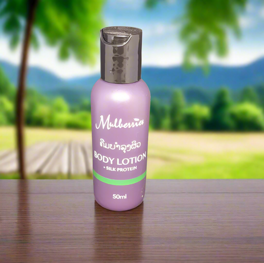 A 50ml bottle of Mulberries All Natural Body Lotion with Silk Protein, set against a natural background with trees and a cap on the bottle.