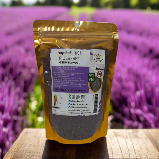 Product shot of a 600g pouch of Lao Souvenir Riceberry Germ Powder on a white background. The packaging is white and purple with gold accents, featuring text that reads "Premium Quality", "100% Natural", "Gluten Free", "High Antioxidant", and "High Fiber".
