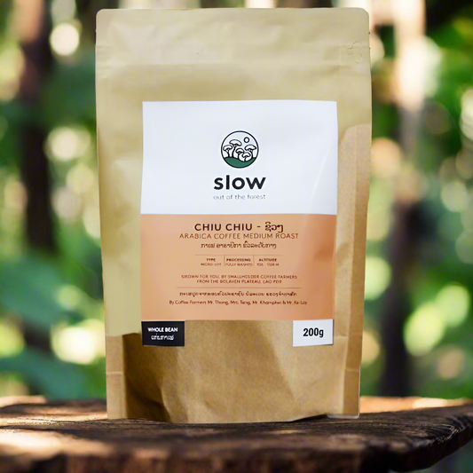 A packaged bag of Slow Chiu Chiu Arabica Coffee Medium Roast displayed outdoors.