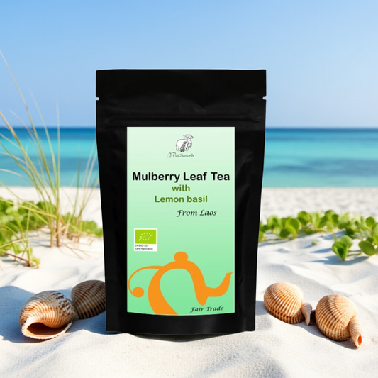 Mulberry Leaf Tea package with lemon basil on a beach