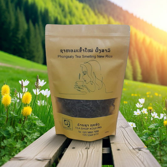 Tea packaging with a scenic background of green fields and flowers