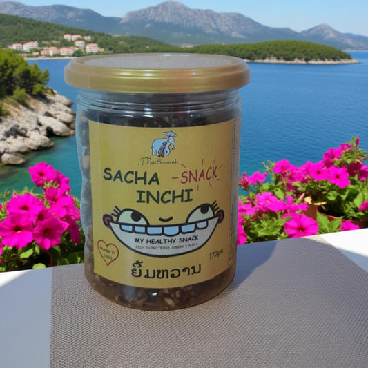 Jar of Sacha Snack Inchi with a scenic background of mountains and water.
