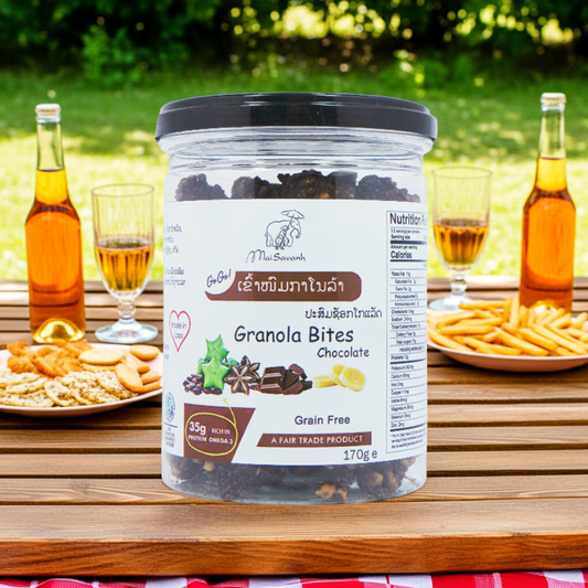 Jar of Granola Bites on a table with snacks and drinks in the background