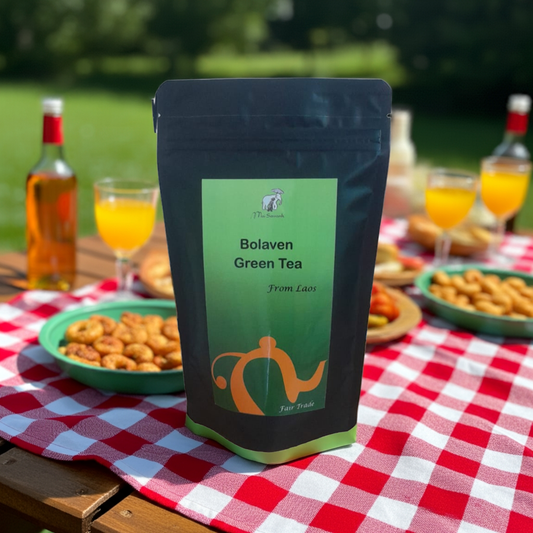 Bag of Bolaven Green Tea on a picnic table with food and drinks in the background